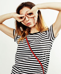 Image showing young pretty teenage hipster girl posing emotional happy smiling on white background, lifestyle people concept 