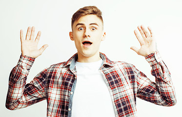 Image showing young handsome teenage hipster guy posing emotional, happy smiling against white background isolated, lifestyle people concept 