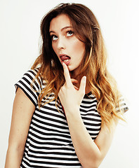 Image showing young pretty teenage hipster girl posing emotional happy smiling on white background, lifestyle people concept 