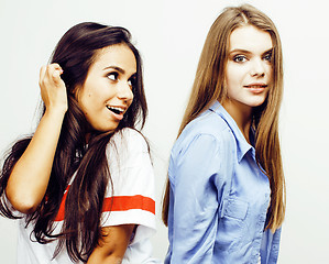 Image showing best friends teenage girls together having fun, posing emotional on white background, besties happy smiling, lifestyle people concept, blond and brunette multi nations 