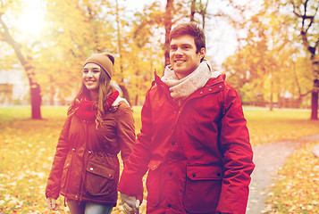 Image showing happy young couple walking in autumn park