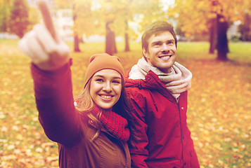 Image showing happy young couple walking in autumn park