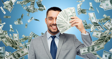 Image showing smiling businessman with american dollar money