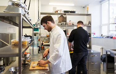 Image showing chef and cook cooking food at restaurant kitchen