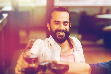 Image showing happy man clinking glass of wine at restaurant