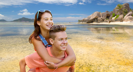 Image showing happy teenage couple having fun on summer beach