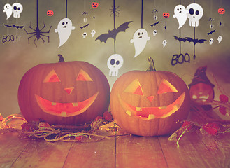 Image showing carved pumpkins in witch hat and halloween garland