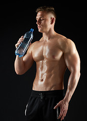 Image showing young man or bodybuilder with bottle of water