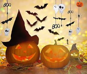 Image showing carved pumpkins in witch hat and halloween garland