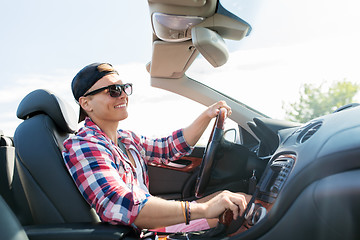 Image showing happy young man driving convertible car