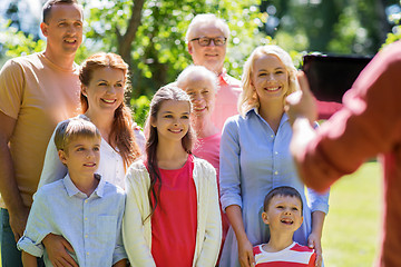 Image showing happy family photographing by tablet pc in summer