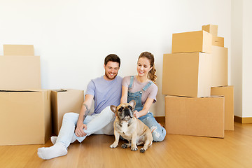 Image showing happy couple with boxes and dog moving to new home