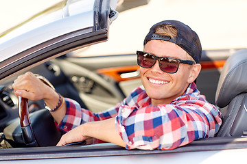 Image showing happy young man in shades driving convertible car
