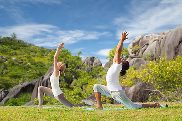 Image showing couple making yoga in low lunge pose outdoors