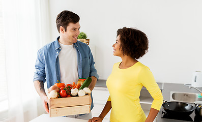 Image showing happy couple with healthy food at home kitchen