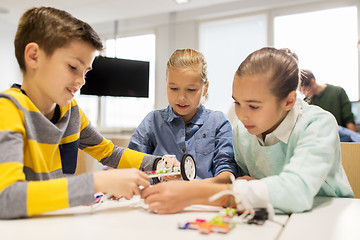 Image showing happy children building robots at robotics school