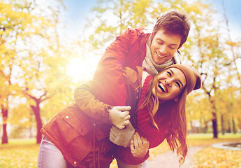 Image showing happy young couple hugging in autumn park