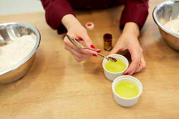 Image showing chef adding food color into bowl with egg whites