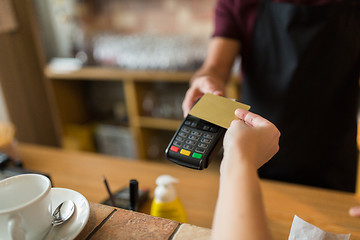 Image showing hands with payment terminal and credit card