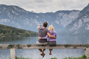 Image showing Embraced couple watching tranquil overcast morning scene at lake Bohinj, Alps mountains, Slovenia.