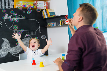 Image showing Cute little toddler boy at speechtherapist session.