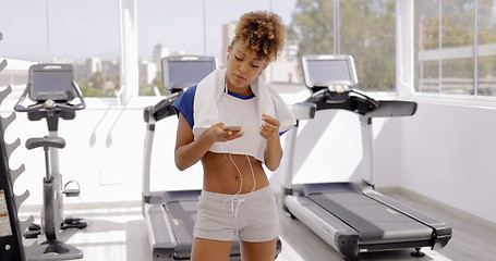 Image showing Girl with phone in gym