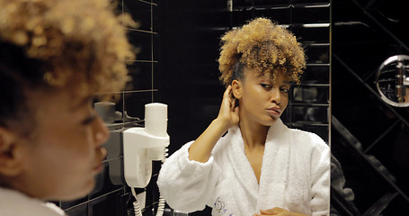 Image showing Confident woman grooming in glass