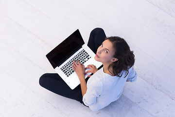 Image showing women using laptop computer on the floor top view