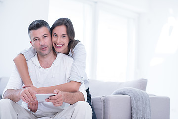 Image showing happy couple using mobile phone at home