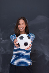 Image showing woman holding a soccer ball in front of chalk drawing board