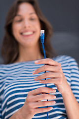 Image showing woman holding a internet cable in front of chalk drawing board