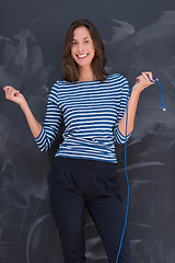 Image showing woman holding a internet cable in front of chalk drawing board