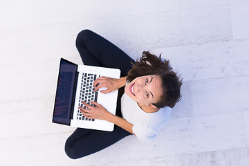 Image showing women using laptop computer on the floor top view