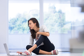 Image showing young women using laptop computer on the floor