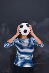 Image showing woman holding a soccer ball in front of chalk drawing board