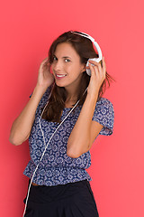 Image showing woman with headphones isolated on a red