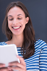 Image showing woman using tablet  in front of chalk drawing board