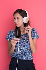 Image showing woman with headphones isolated on a red