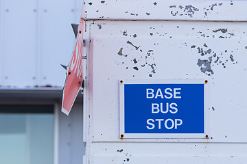 Image showing Bus stop sign on a wall