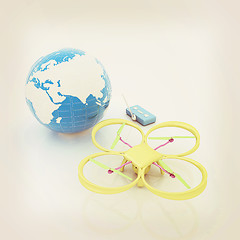 Image showing Quadrocopter Drone with Earth Globe and remote controller on a w