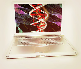 Image showing Laptop with dna medical model background on laptop screen. 3d il