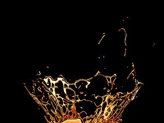 Image showing Melted gold or oil splashes isolated on black