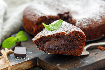 Image showing Piece of chocolate cake dusted with powdered sugar.