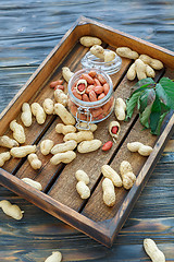 Image showing Glass jar with peeled peanuts.