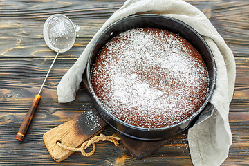 Image showing Chocolate cake sprinkled with powdered sugar.