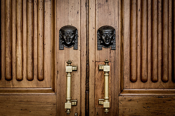 Image showing Sphinx heads entrance on wooden door