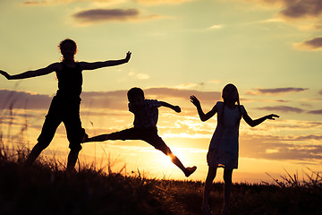 Image showing Happy children playing in the park at the sunset time.