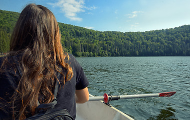Image showing Girl back view sailing on lake