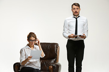 Image showing The young man and beautiful woman in business suit at office on white background