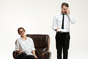 Image showing The young man and beautiful woman in business suit at office on white background